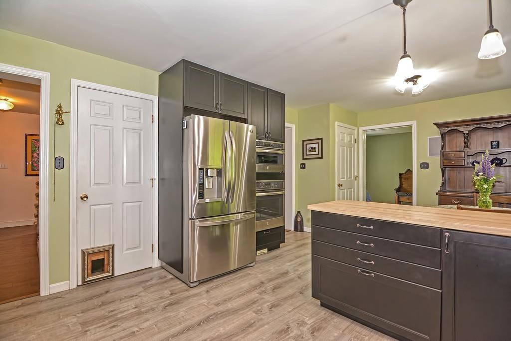 173 Webster Street Douglas, MA 01516 - Photo 6 of 42 a kitchen with a refrigerator and a sink