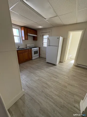 a kitchen with a refrigerator sink and cabinets