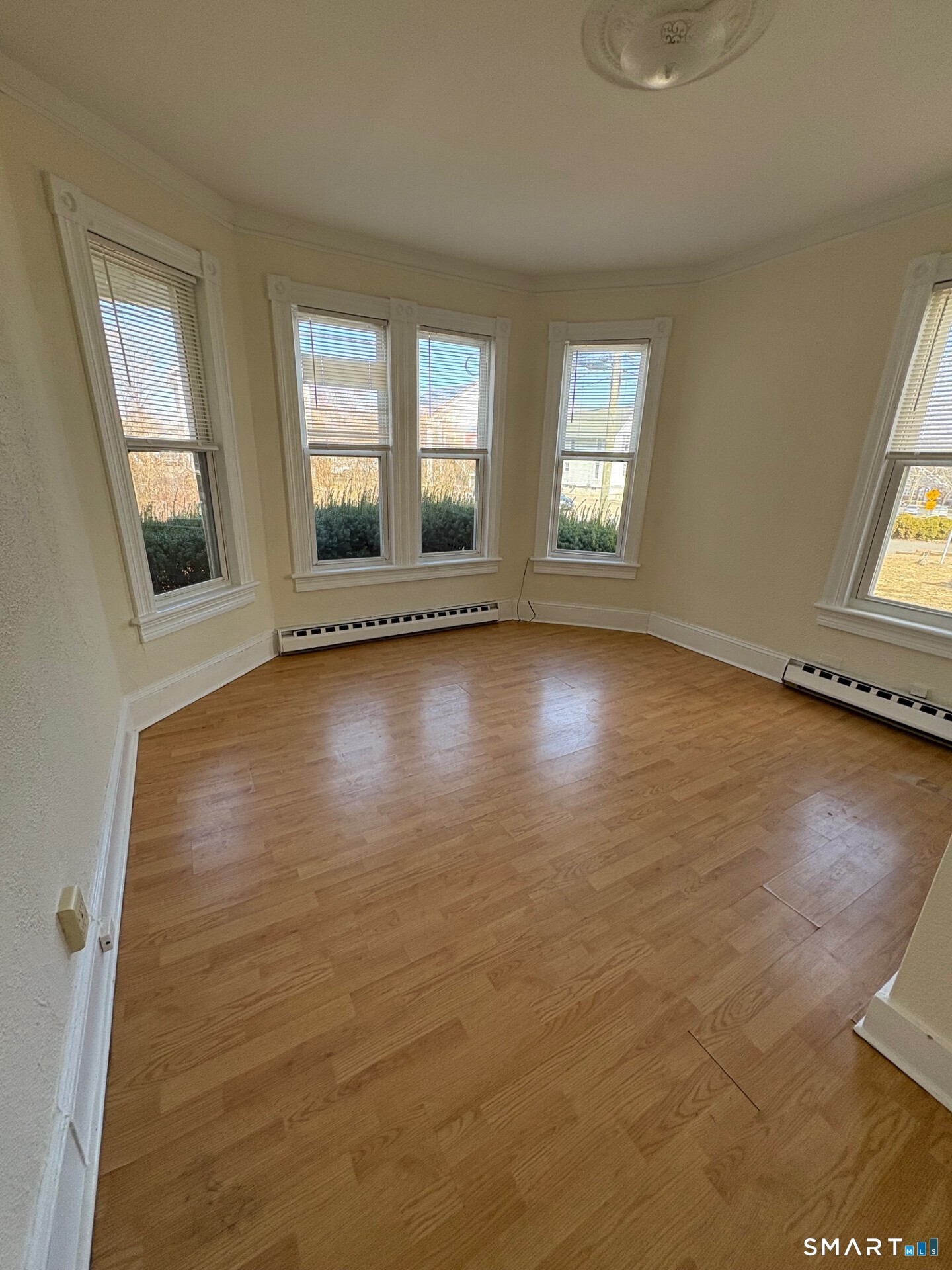 55 Beaver Brook Road, Unit 2 Danbury, CT 06810 - Photo 5 of 9 an empty room with wooden floor and windows