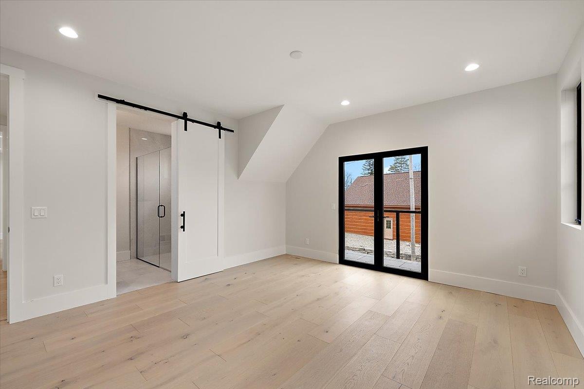 13459 Haddon Street Fenton, MI 48430 - Photo 52 of 84 Bonus room with a barn door, light wood-style floors, and recessed lighting