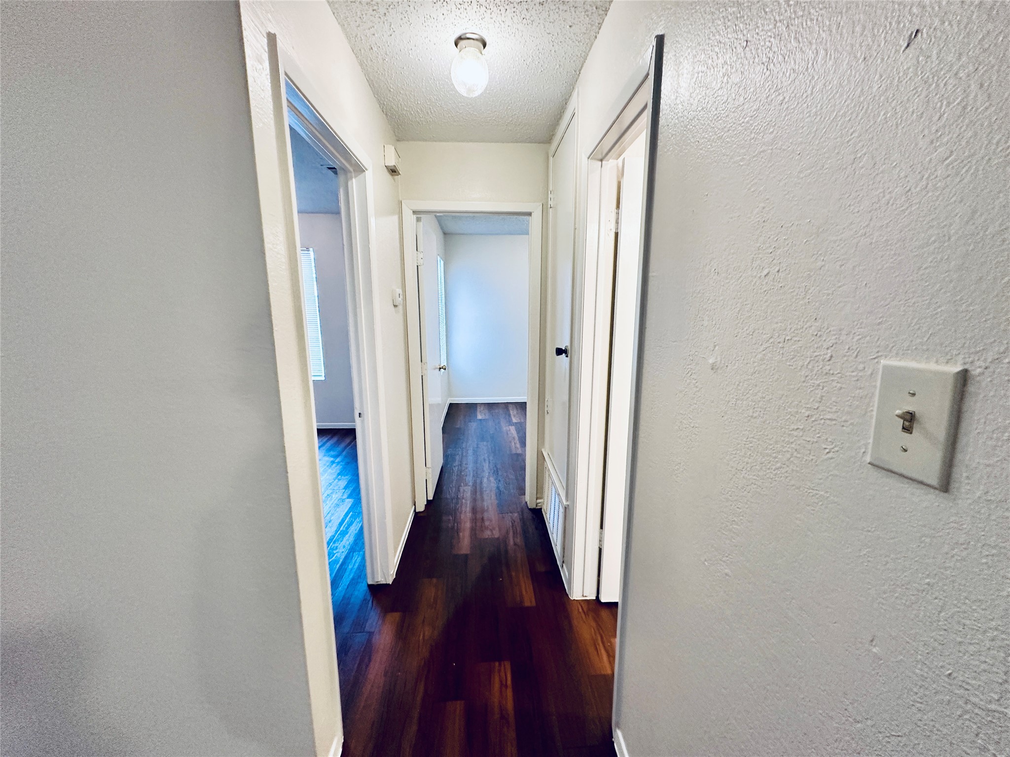 12505 Turtle Rock Road, Unit A Austin, TX 78729 - Photo 20 of 38 Rich hardwood floors guide you through this inviting interior hallway.