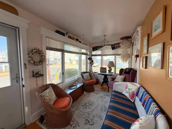 a living room with furniture fireplace and large windows