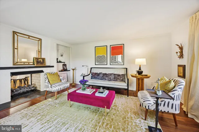 a living room with furniture and a painting on the wall