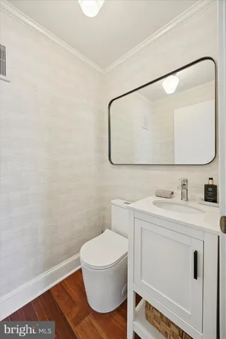 a bathroom with a sink a toilet and mirror
