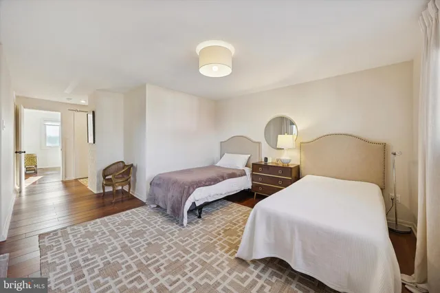 a bedroom with two beds and a chandelier