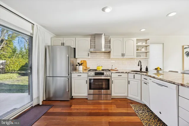 a kitchen with a refrigerator sink and cabinets