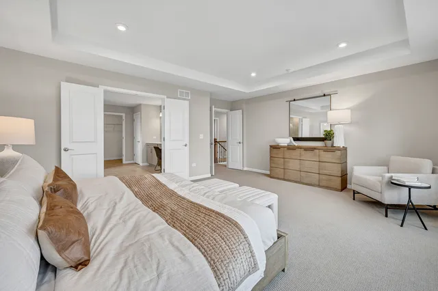 a spacious bedroom with a bed and a couch