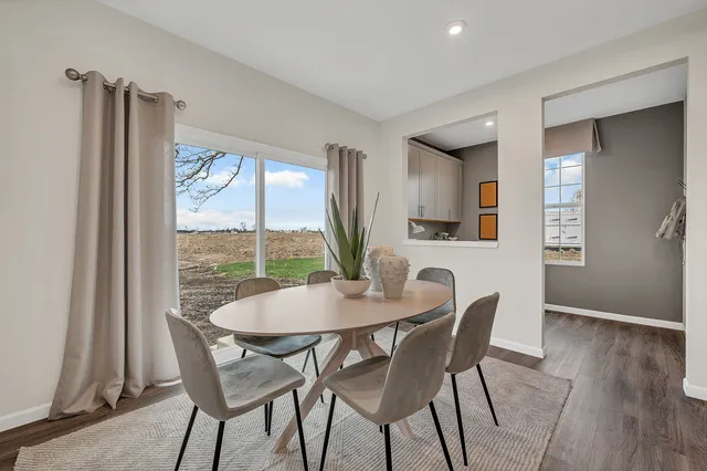 a view of a dining room with furniture and window