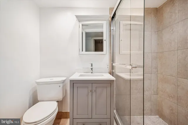 a bathroom with a toilet a sink and mirror