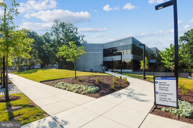 a view of a cafe with table and chairs under an umbrella