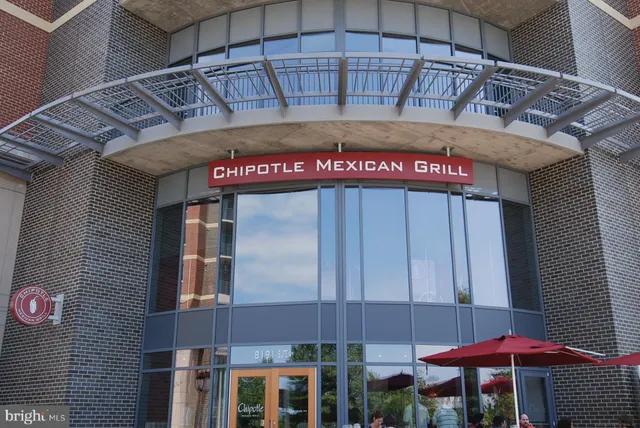 a view of brick house with potted plants