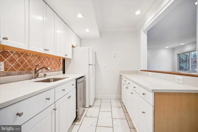 a kitchen with granite countertop a sink and a stove