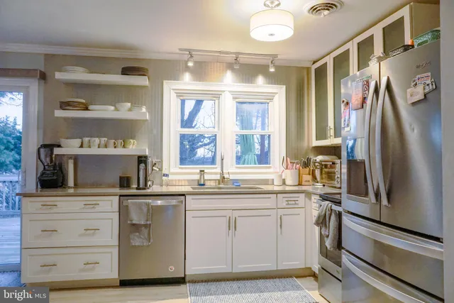a kitchen with a sink stove and refrigerator