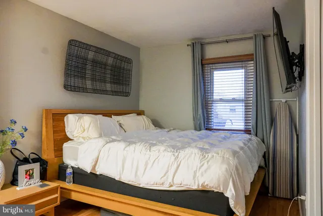 a bedroom with a bed and a window