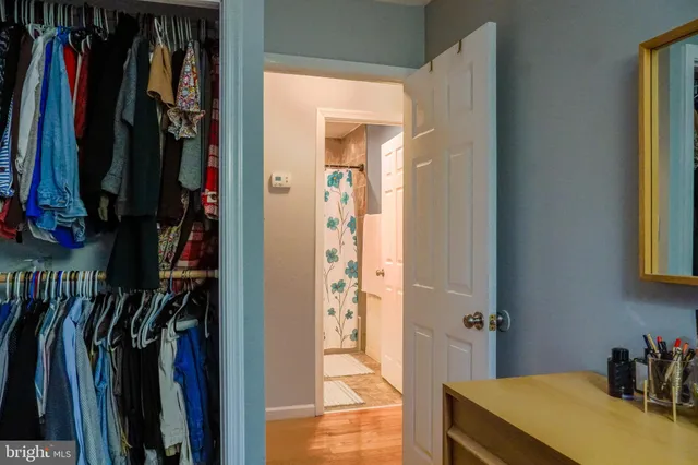 a view of walk in closet with clothes and shoes