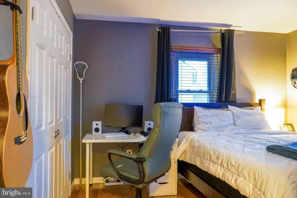 a bedroom with a bed and a desk