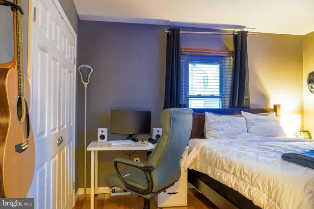 a bedroom with a bed and a desk