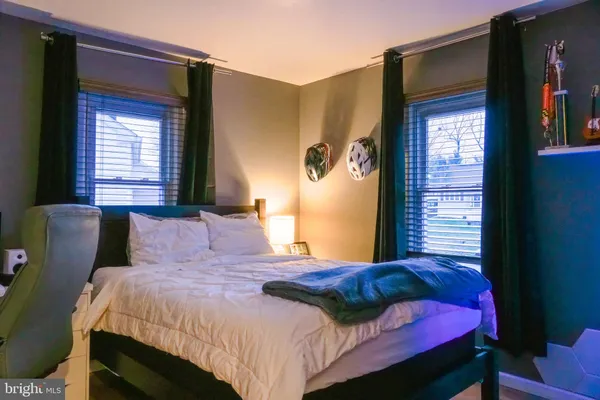 a bedroom with a bed and a potted plant