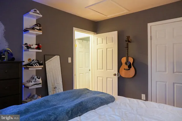 a bedroom with a bed and cabinets