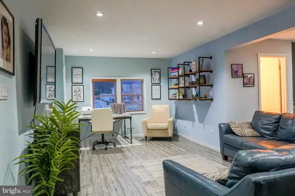 a living room with furniture and a potted plant