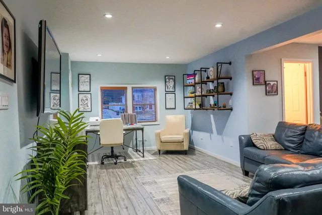 a living room with furniture and a potted plant