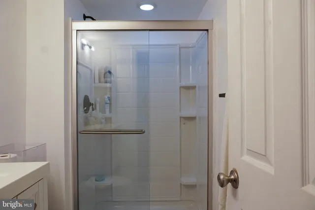 a bathroom with a glass shower door