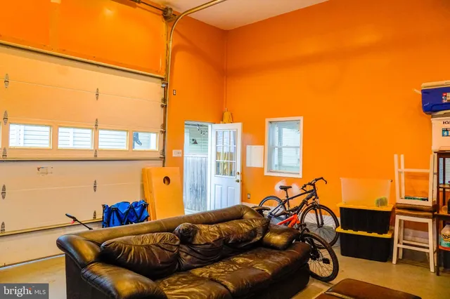 a living room with a bed and a window