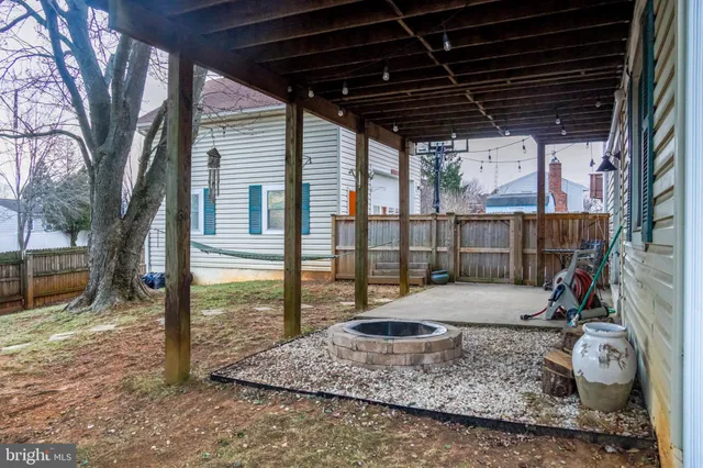 a view of a backyard with wooden fence