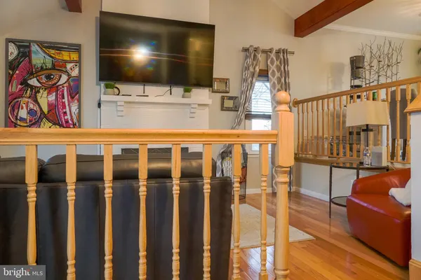 a view of a living room with furniture and flat screen tv