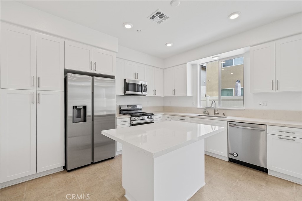 1942 North Florish Drive Compton, CA 90222 - Photo 15 of 47 a kitchen with stainless steel appliances a refrigerator sink and microwave