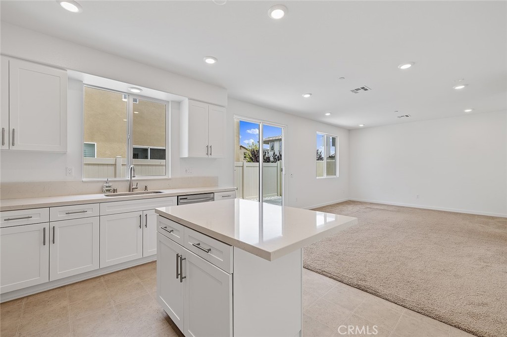 1942 North Florish Drive Compton, CA 90222 - Photo 16 of 47 a large kitchen with stainless steel appliances granite countertop a sink and dishwasher with white cabinets