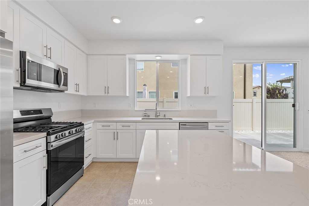 1942 North Florish Drive Compton, CA 90222 - Photo 18 of 47 a kitchen with stainless steel appliances granite countertop a stove top oven a sink and a refrigerator