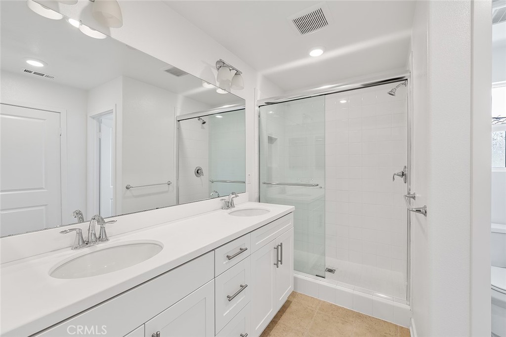 1942 North Florish Drive Compton, CA 90222 - Photo 33 of 47 a bathroom with a double vanity sink mirror double and shower