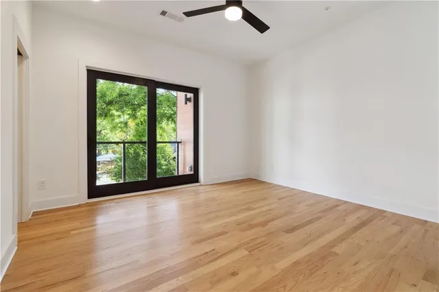 a view of an empty room with wooden floor