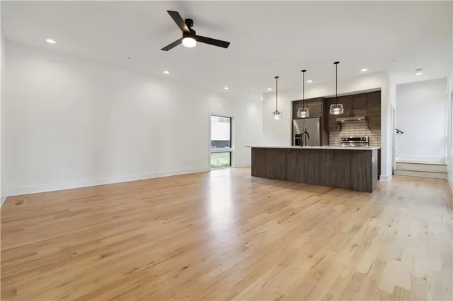 a large kitchen with a large refrigerator a oven and a counter top