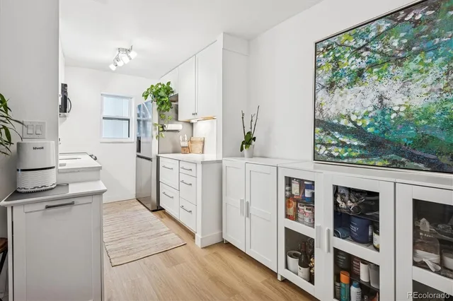 a view of a kitchen with furniture and wooden floor