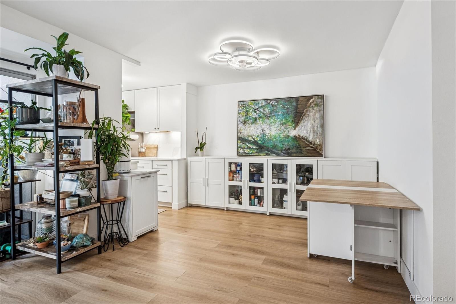 2 Adams Street, Unit 510 Denver, CO 80206 - Photo 12 of 37 a view of a kitchen with furniture and wooden floor