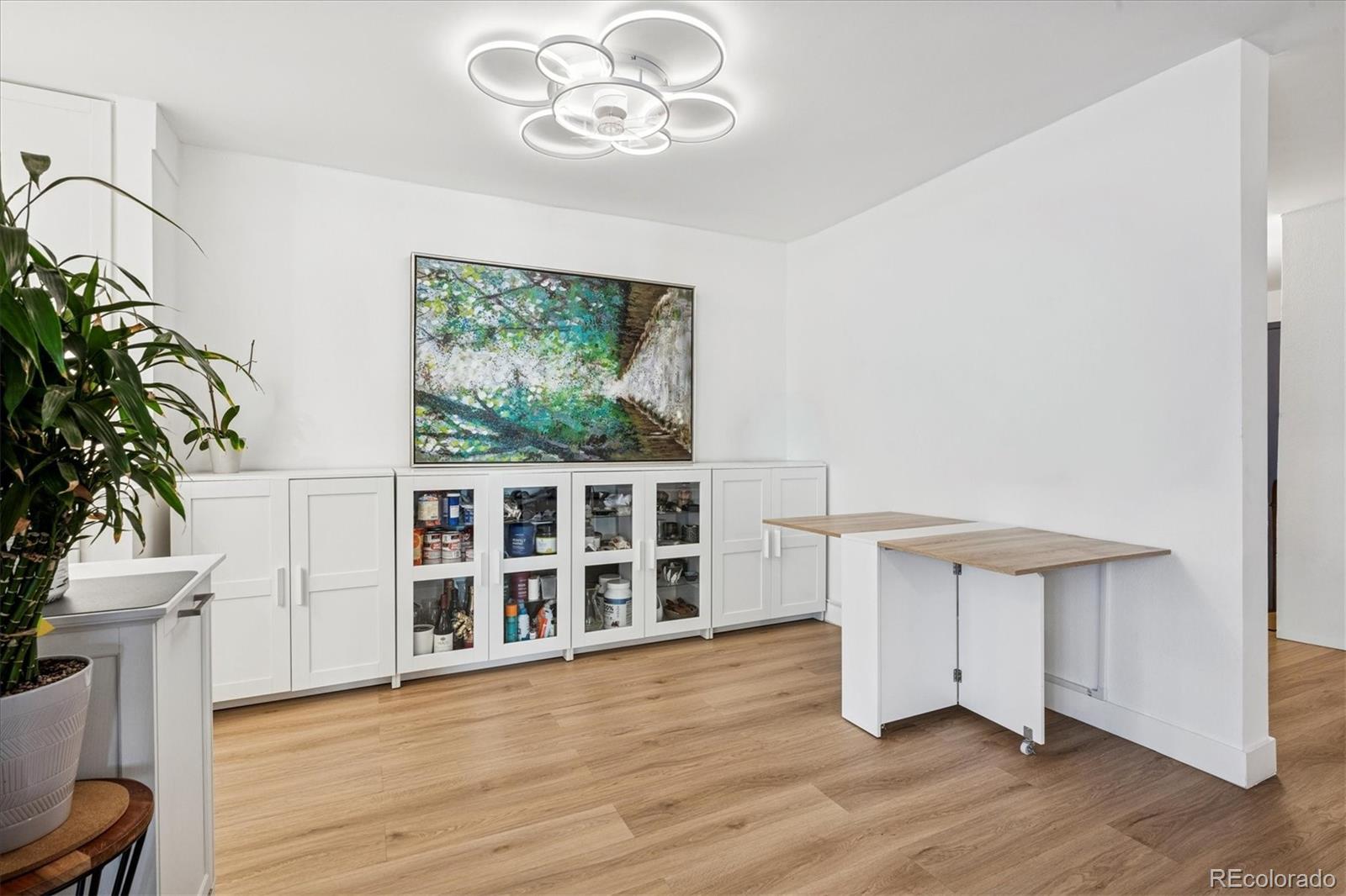 2 Adams Street, Unit 510 Denver, CO 80206 - Photo 15 of 37 a view of an empty room with a window and wooden floor