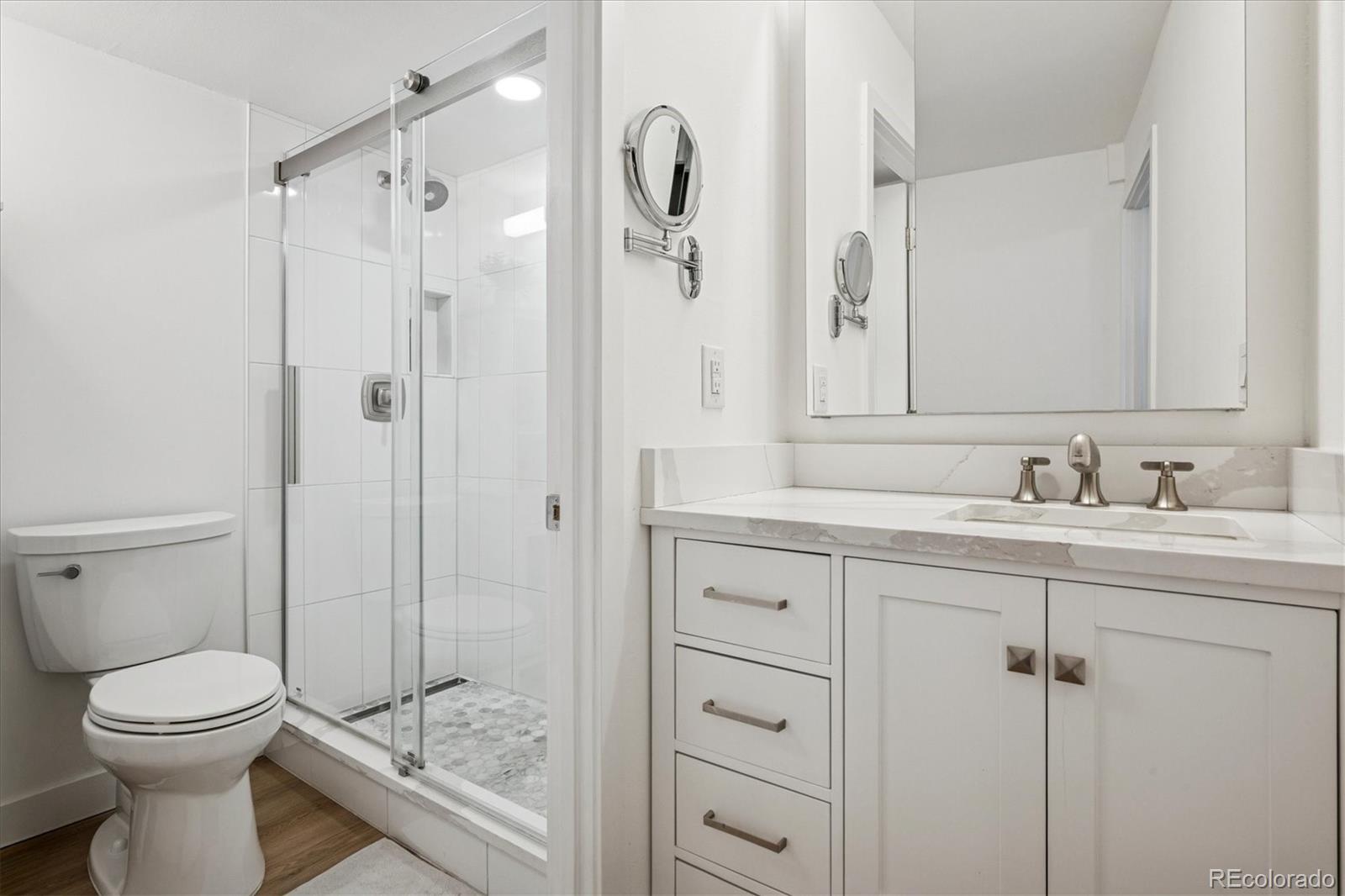 2 Adams Street, Unit 510 Denver, CO 80206 - Photo 19 of 37 a bathroom with a sink a toilet and shower