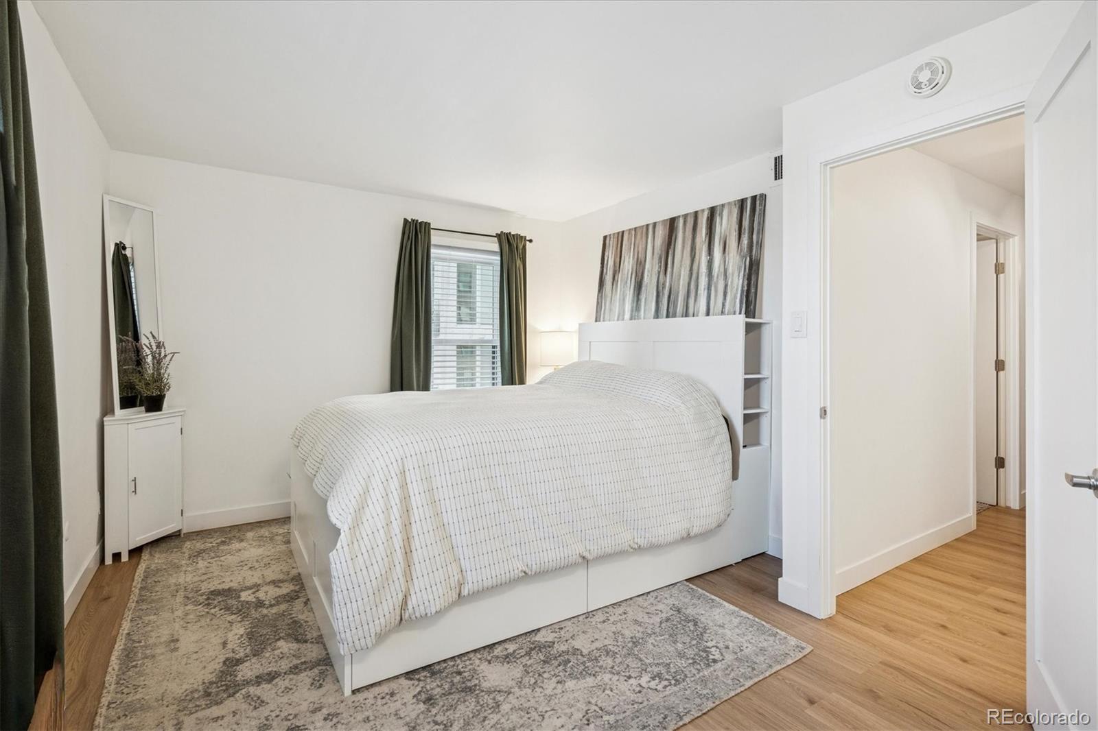 2 Adams Street, Unit 510 Denver, CO 80206 - Photo 21 of 37 a bed room with a bed and a window