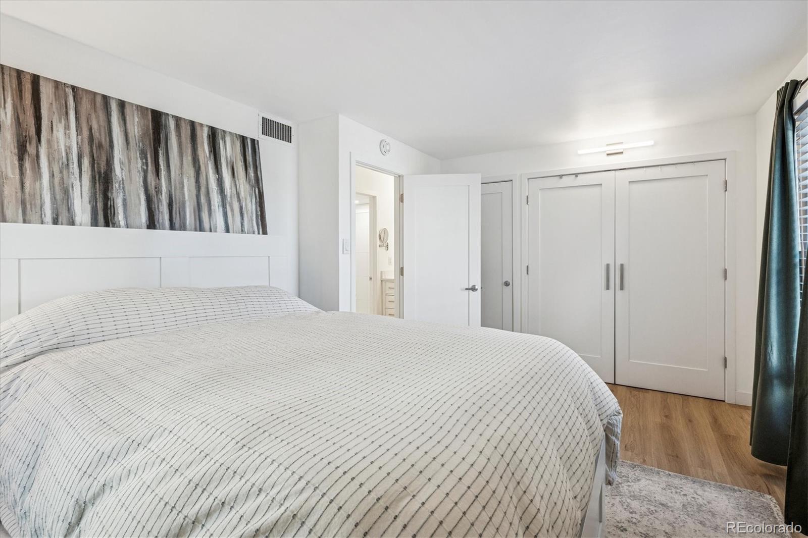 2 Adams Street, Unit 510 Denver, CO 80206 - Photo 22 of 37 a view of a bedroom with wooden floor