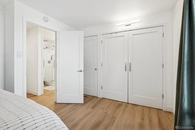 a large bed sitting in a bedroom next to a window