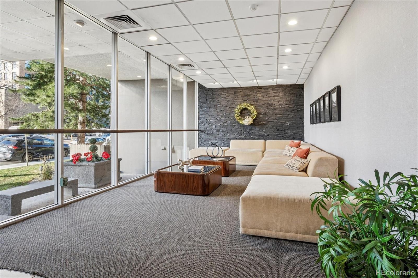 2 Adams Street, Unit 510 Denver, CO 80206 - Photo 30 of 37 a living room with furniture and a flat screen tv