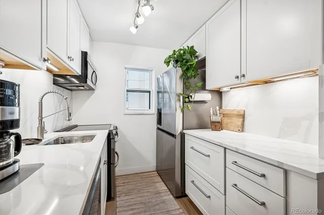 a kitchen with cabinets and window