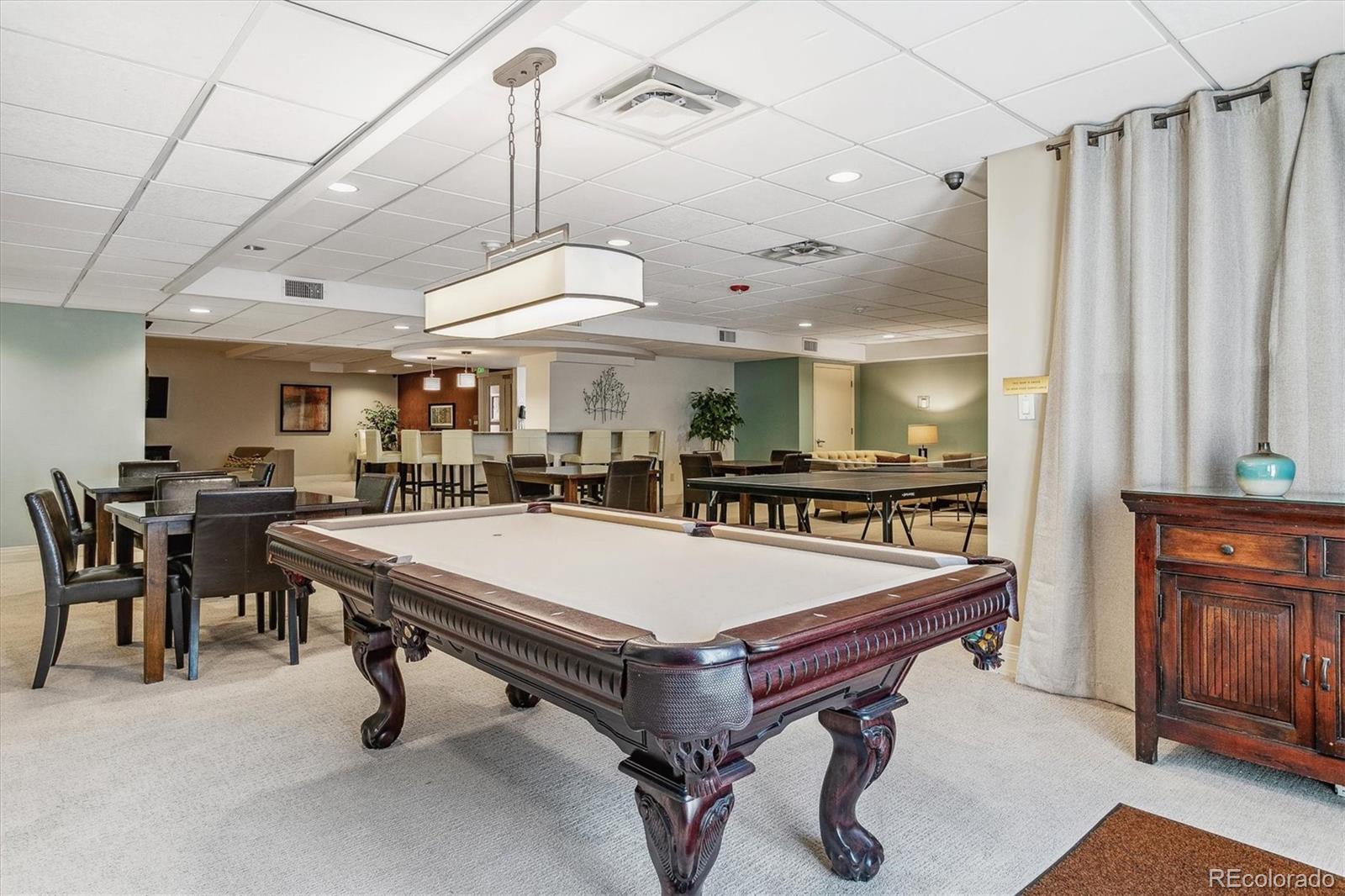 2 Adams Street, Unit 510 Denver, CO 80206 - Photo 36 of 37 a room with table chairs and a chandelier