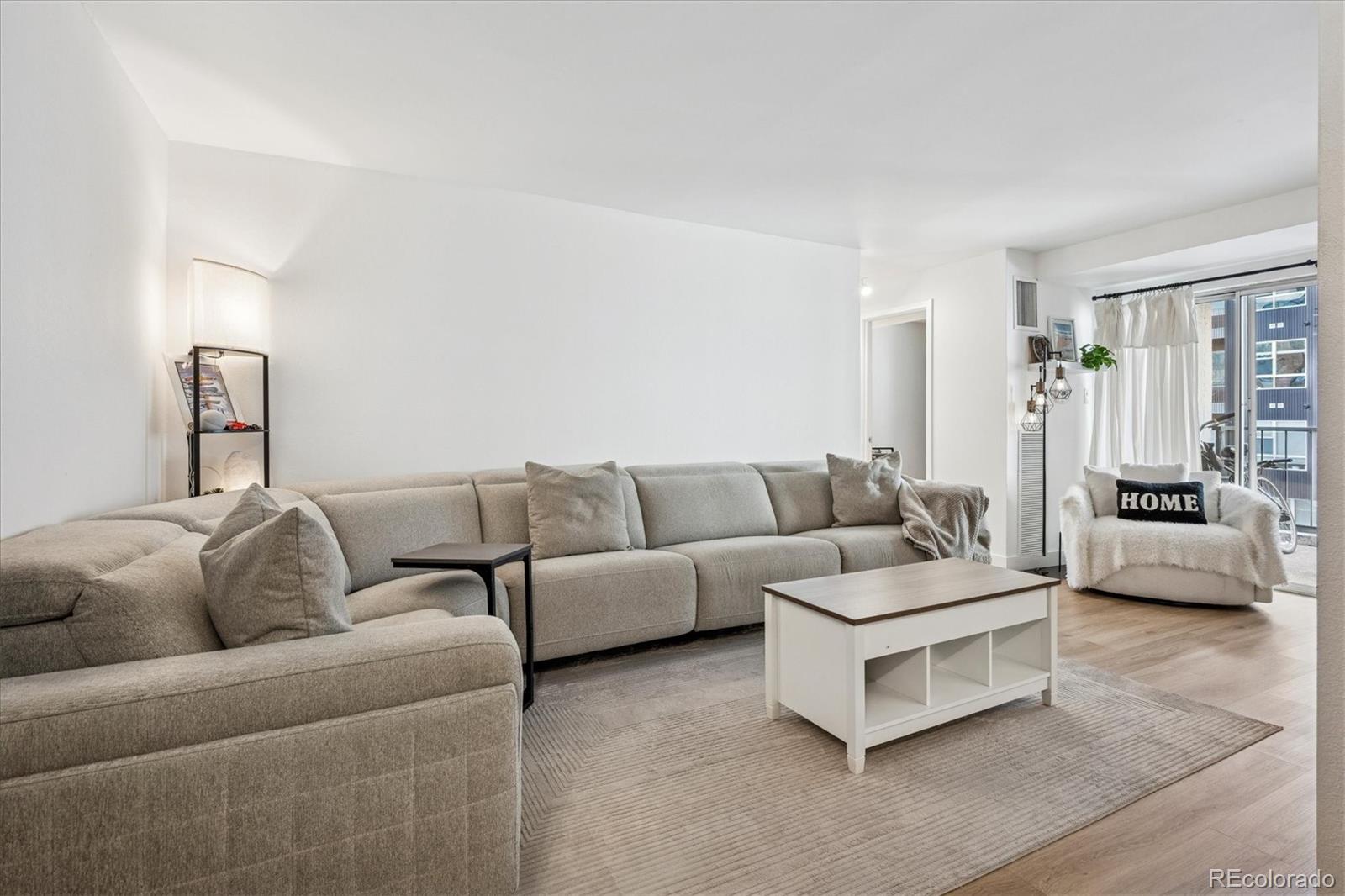 2 Adams Street, Unit 510 Denver, CO 80206 - Photo 6 of 37 a living room with furniture and a couch