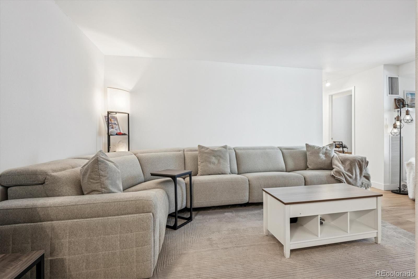 2 Adams Street, Unit 510 Denver, CO 80206 - Photo 7 of 37 a living room with furniture and a couch