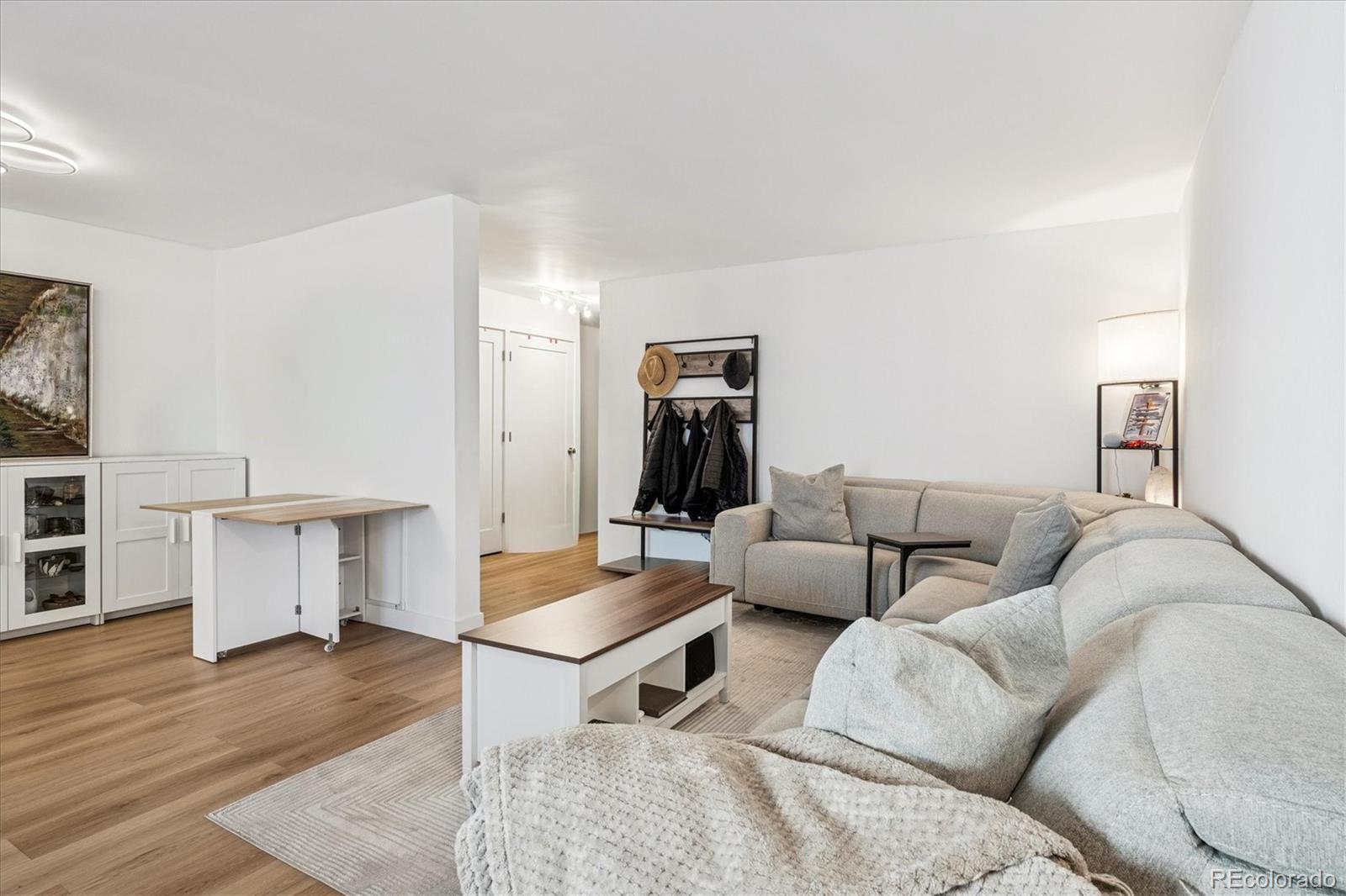 2 Adams Street, Unit 510 Denver, CO 80206 - Photo 9 of 37 a living room with furniture and wooden floor