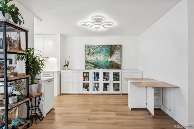 a kitchen with stainless steel appliances kitchen island wooden cabinets and entryway