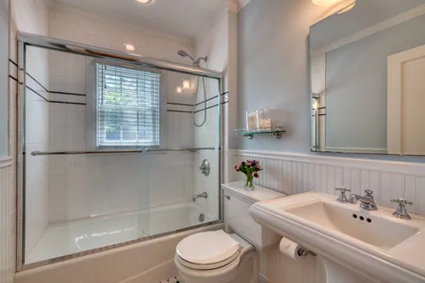 a bathroom with a sink toilet and shower